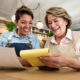 Two cafe owners smiling as they check through the accounts